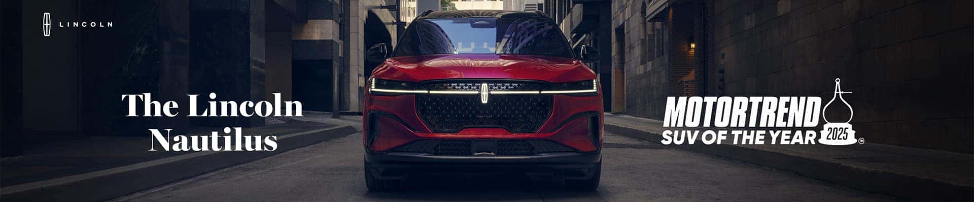Red Lincoln Nautilus in a city street, with text highlighting it as MotorTrend's 2025 SUV of the Year.