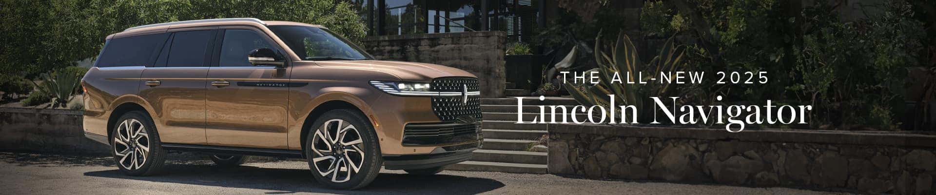 2025 Lincoln Navigator in bronze parked by stone wall, greenery. Launch text overlay.